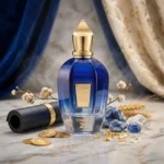 شیشه عطر آبی زرجف تورینو بیست و یک روی مرمر کنار سکه طلا و کریستال