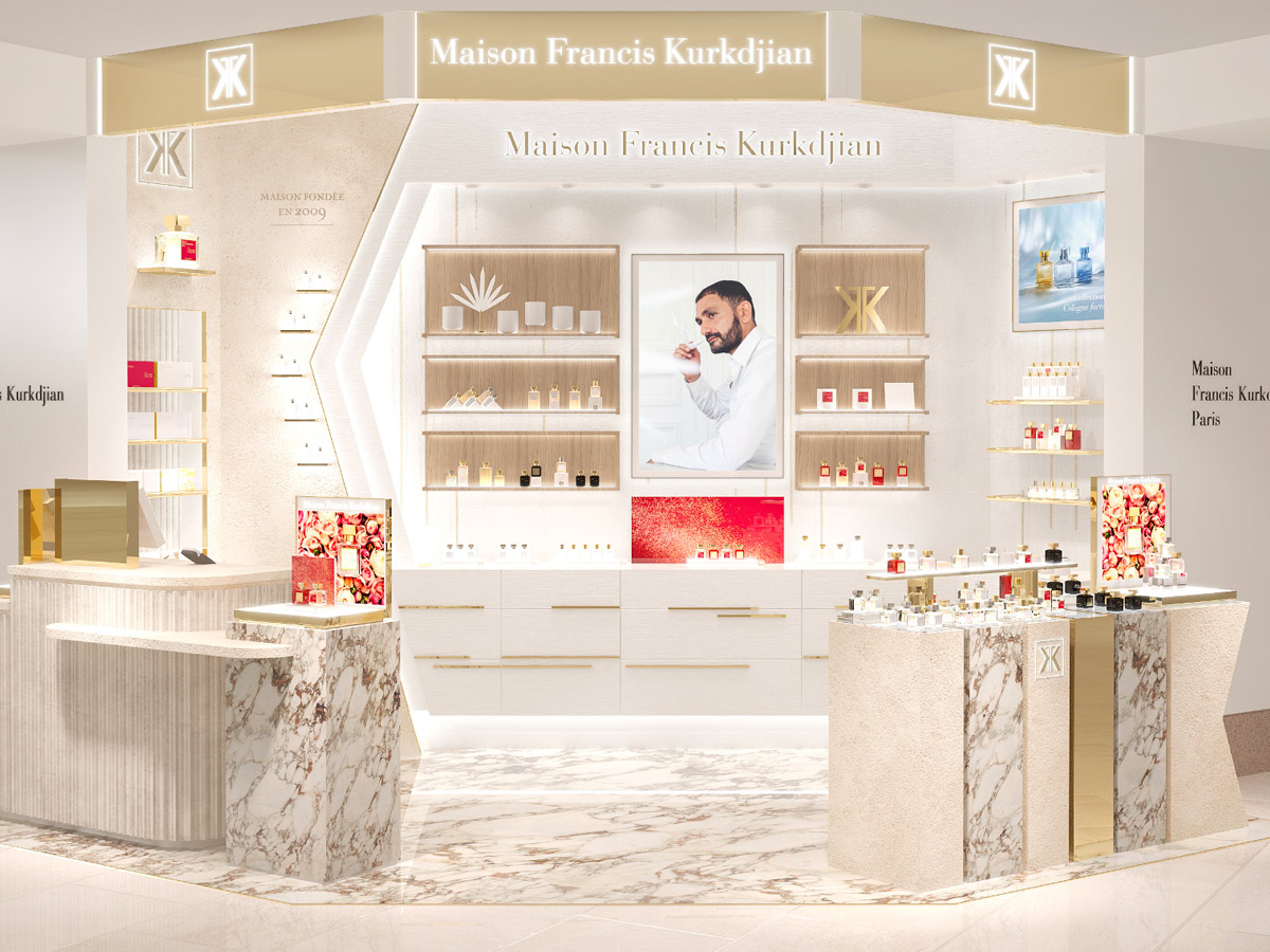 نمای داخلی غرفه لوکس Maison Francis Kurkdjian در یک فروشگاه، با قفسههای پر از عطر و طراحی مینیمال
