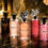 تصویر شاخص مقاله مجموعه عطرهای لوکس لویی ویتون Louis Vuitton چیده شده روی سنگ مرمر مشکی با نورپردازی گرم و حرفه ای